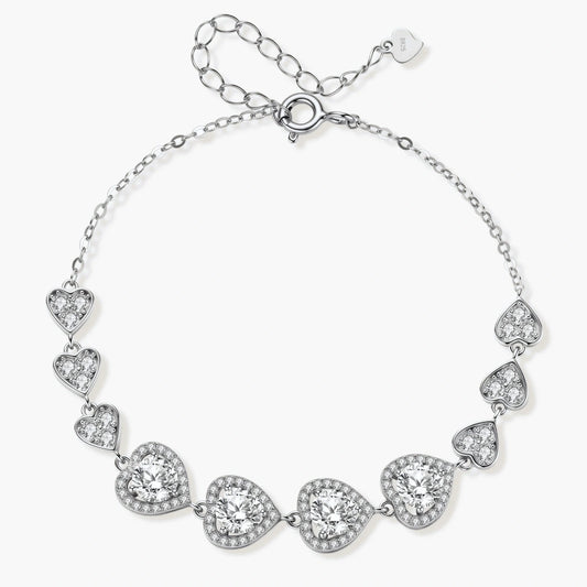 Sterling silver bracelet with graduated heart-shaped links and sparkling moissanite stones in VVS1 clarity on white background.