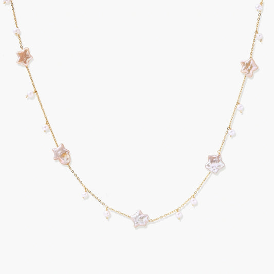 Gold vermeil chain adorned with iridescent star-shaped baroque pearls and delicate round freshwater pearl drops.