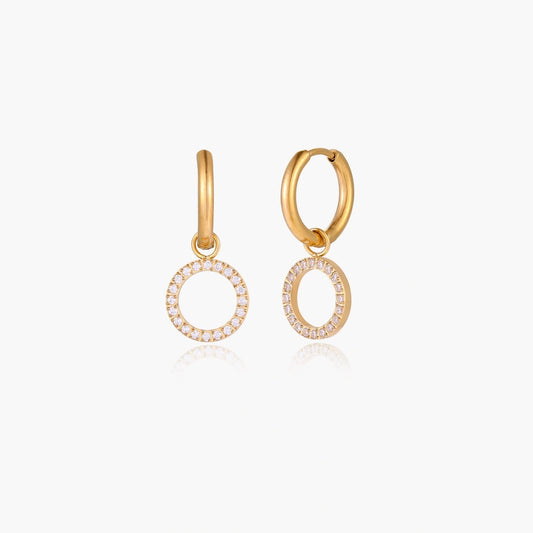 Dainty gold huggie hoop earrings featuring open circle charms adorned with sparkling cubic zirconia.