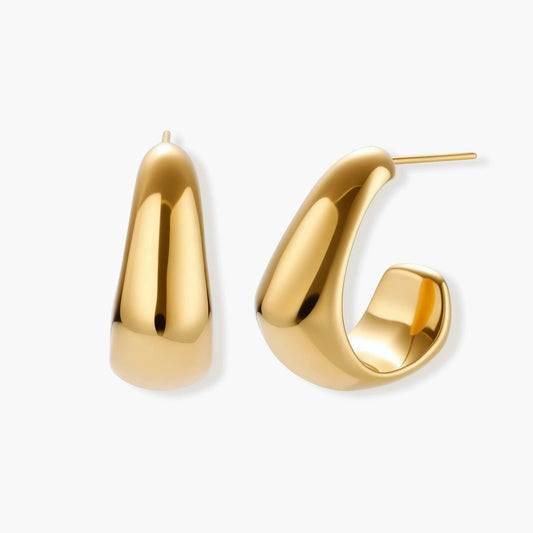 Elegant gold huggie earrings featuring a tapered design that gracefully widens into a sculpted teardrop shape.