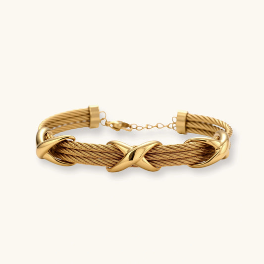Gold-tone bracelet featuring three polished X-shaped knots on twisted cable strands with an adjustable lobster clasp.