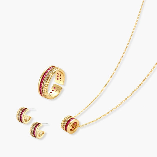 Three-piece jewellery set featuring a necklace and huggie hoop earrings with raspberry-red stones and gold accents.
