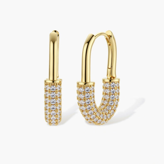 Polished gold huggie hoop earrings featuring multiple rows of sparkling stones in an elegant U-curve design.