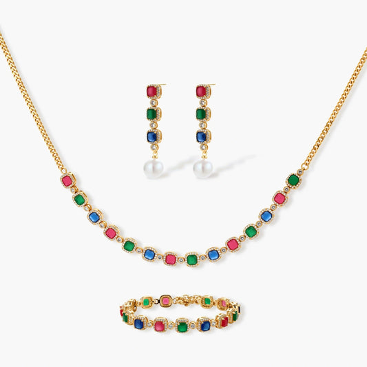 Jewelry set featuring a necklace, earrings, and bracelet adorned with vibrant red, green, and blue stones in gold-toned metal.