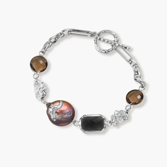 Chunky chain bracelet featuring a baroque pearl, smoky quartz rounds, and a deep black faceted stone with silver nuggets.