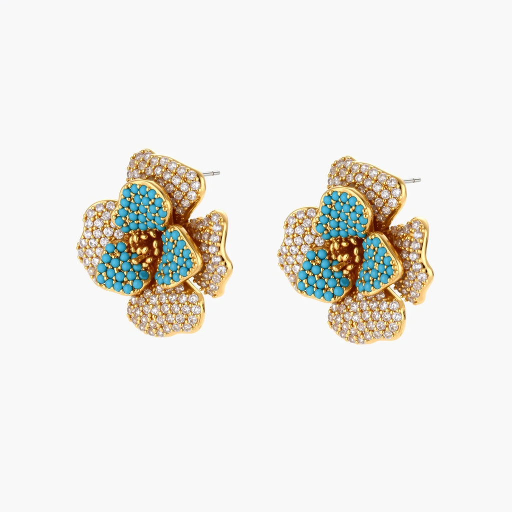 14K gold-plated floral jewelry set with blue cubic zirconia centers and pearl chain details on white background.