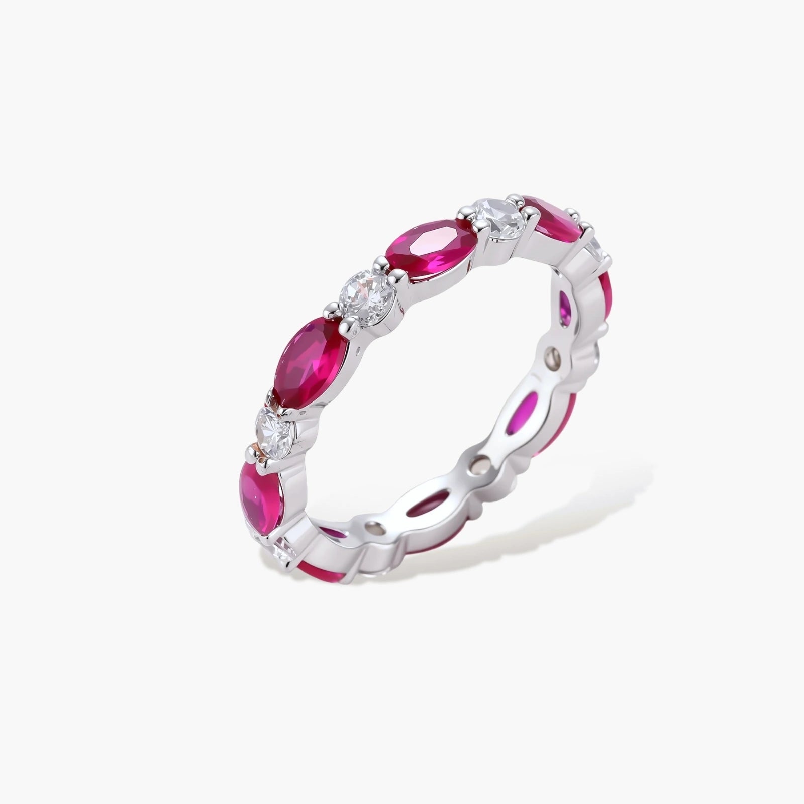 Platinum-plated eternity ring with alternating oval ruby and round clear stones in continuous band setting