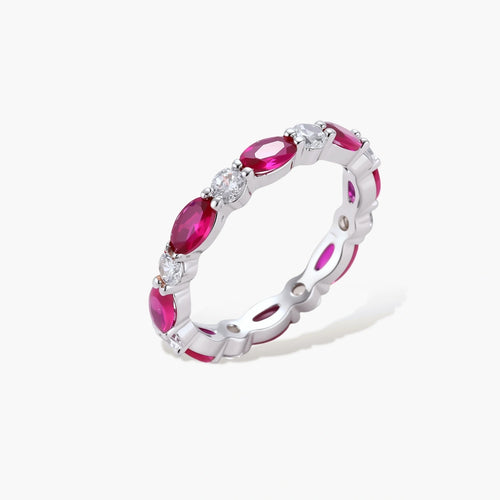 Platinum-plated eternity ring with alternating oval ruby and round clear stones in continuous band setting
