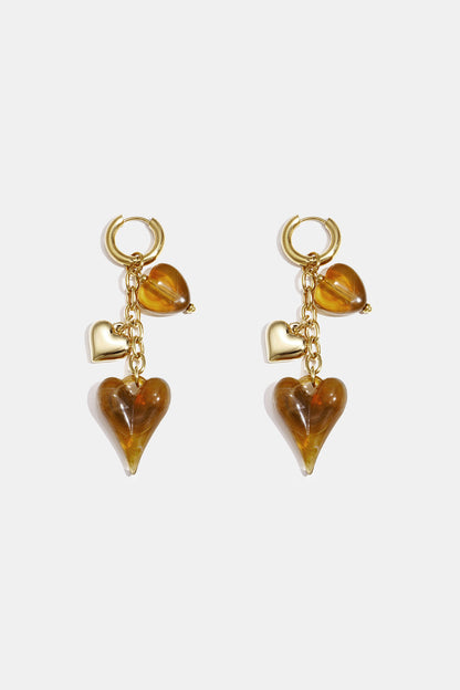 Earrings with dangling hearts on a chain