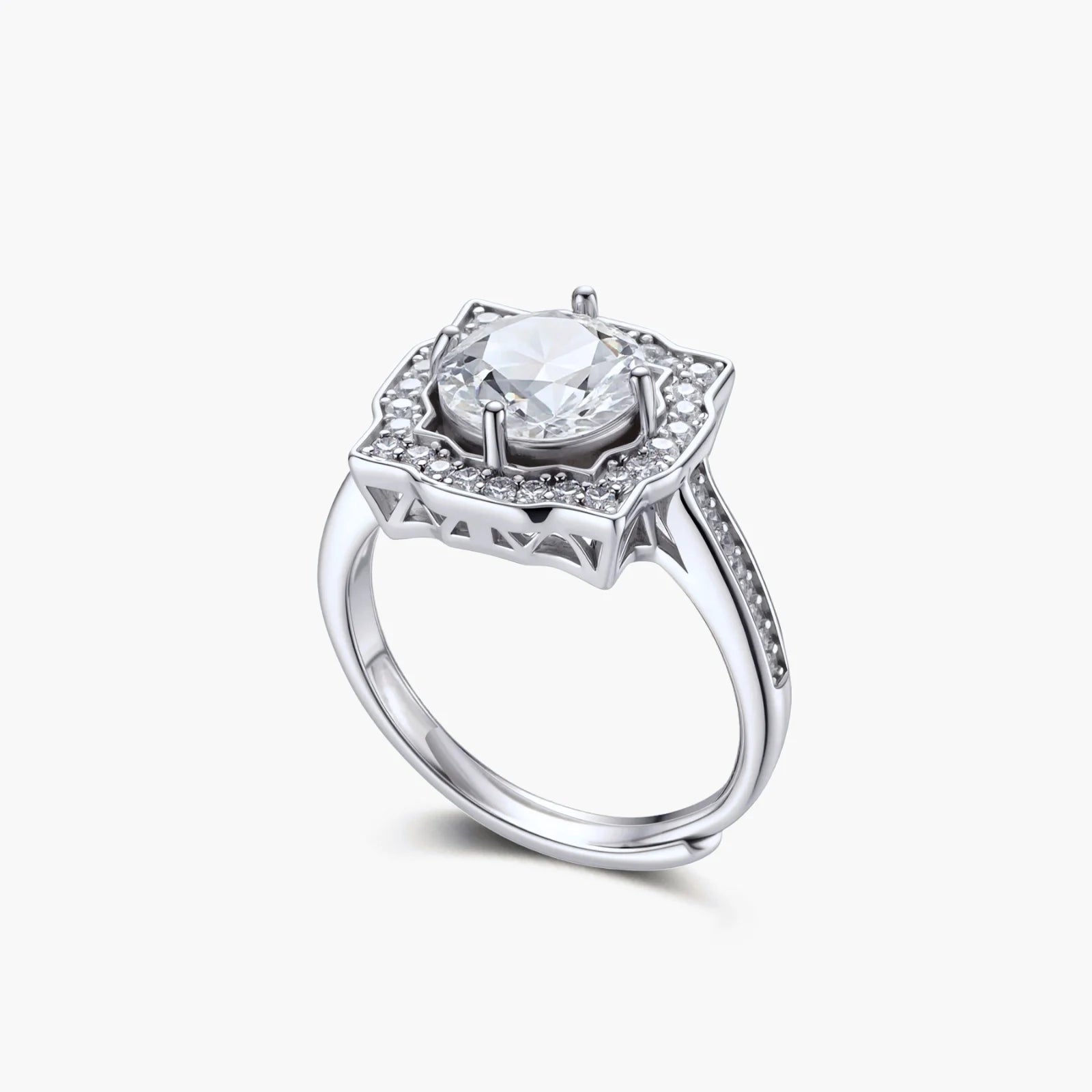 Sterling silver ring with round moissanite center stone in ornate scalloped halo setting on white background.
