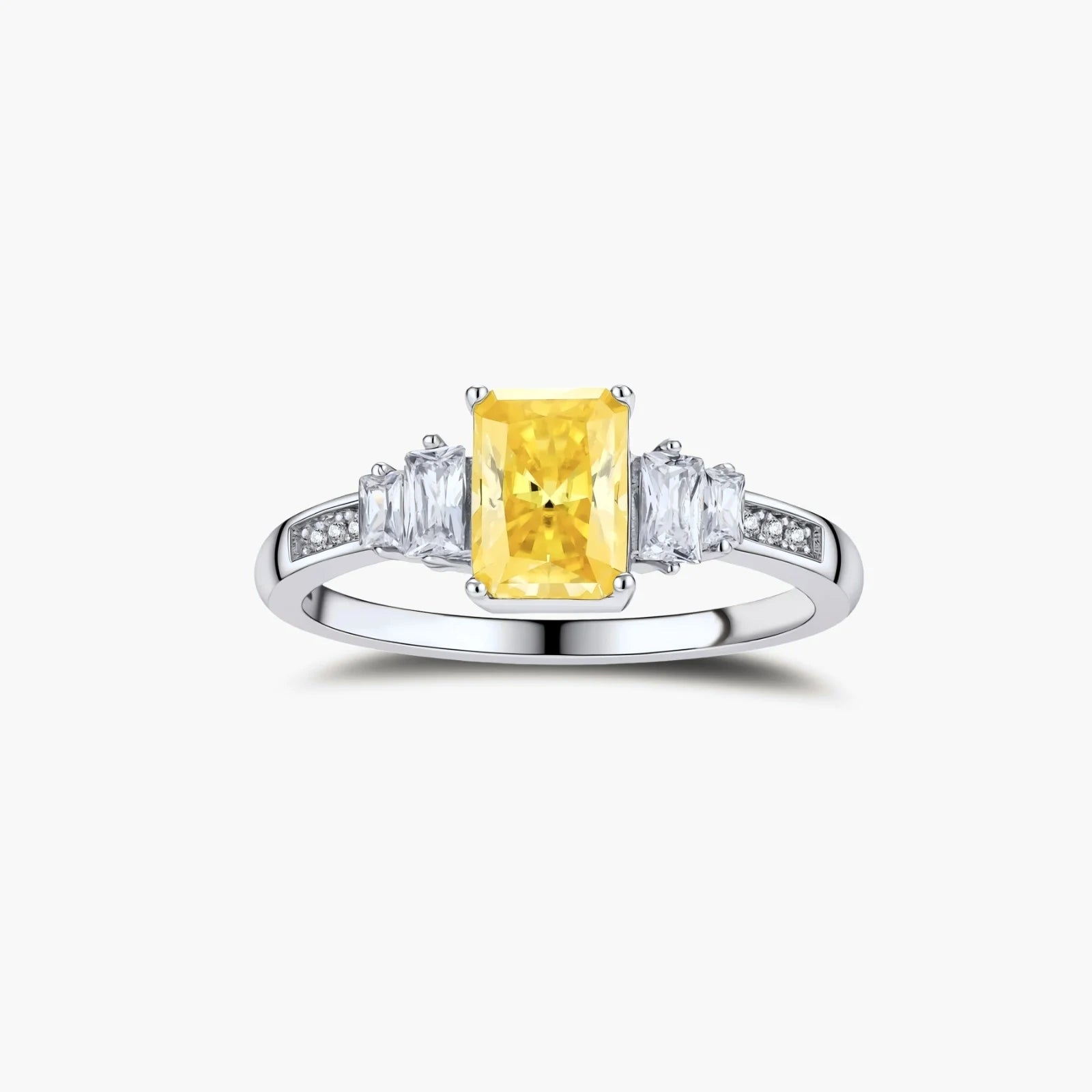 Sterling silver ring with emerald-cut yellow moissanite center stone and clear baguette side stones in elegant setting