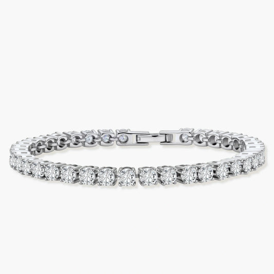 Sterling silver tennis bracelet with continuous row of brilliant moissanite stones and secure clasp closure on cream background.