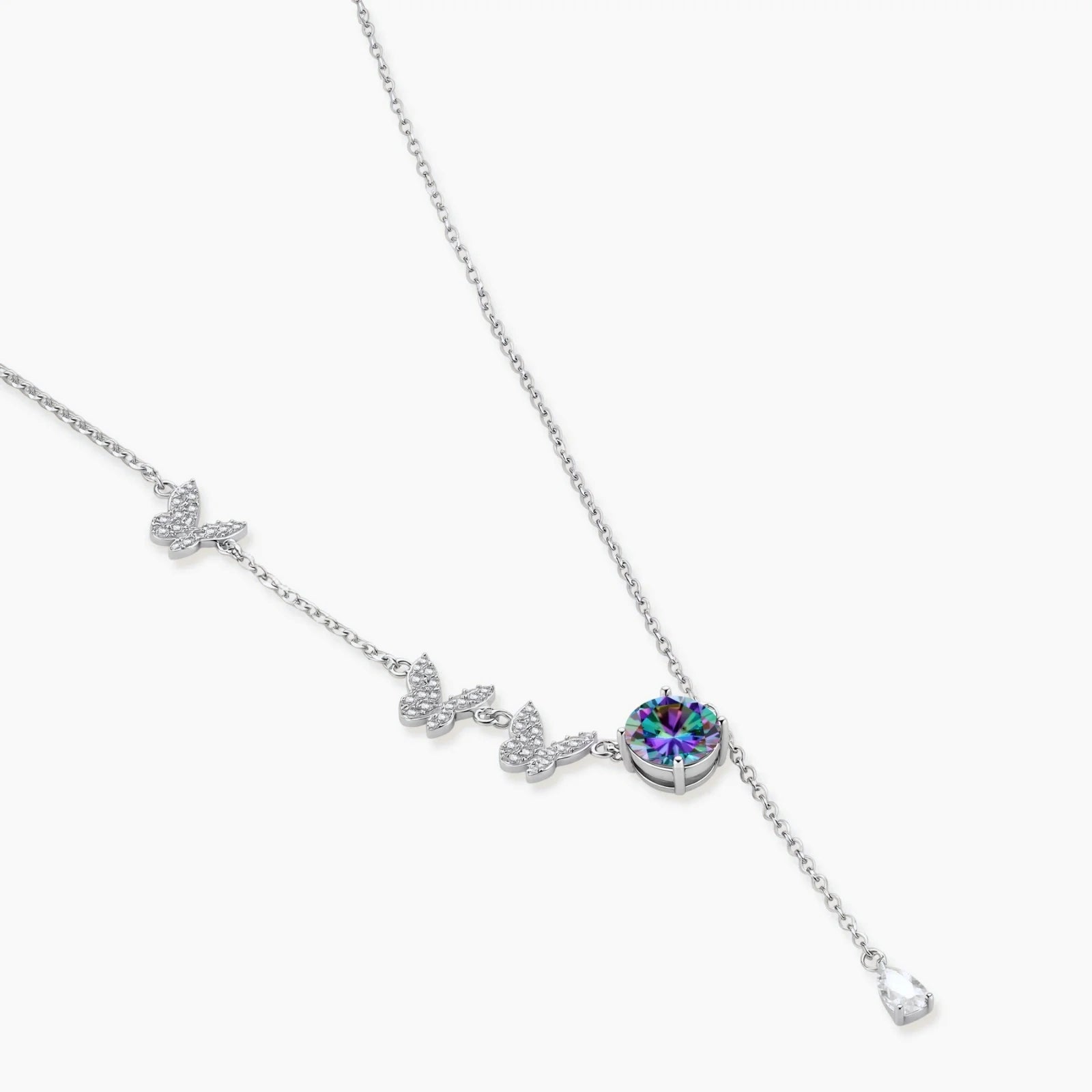 Delicate sterling silver necklace with crystal-set butterfly charms and rainbow moissanite pendant on white background.