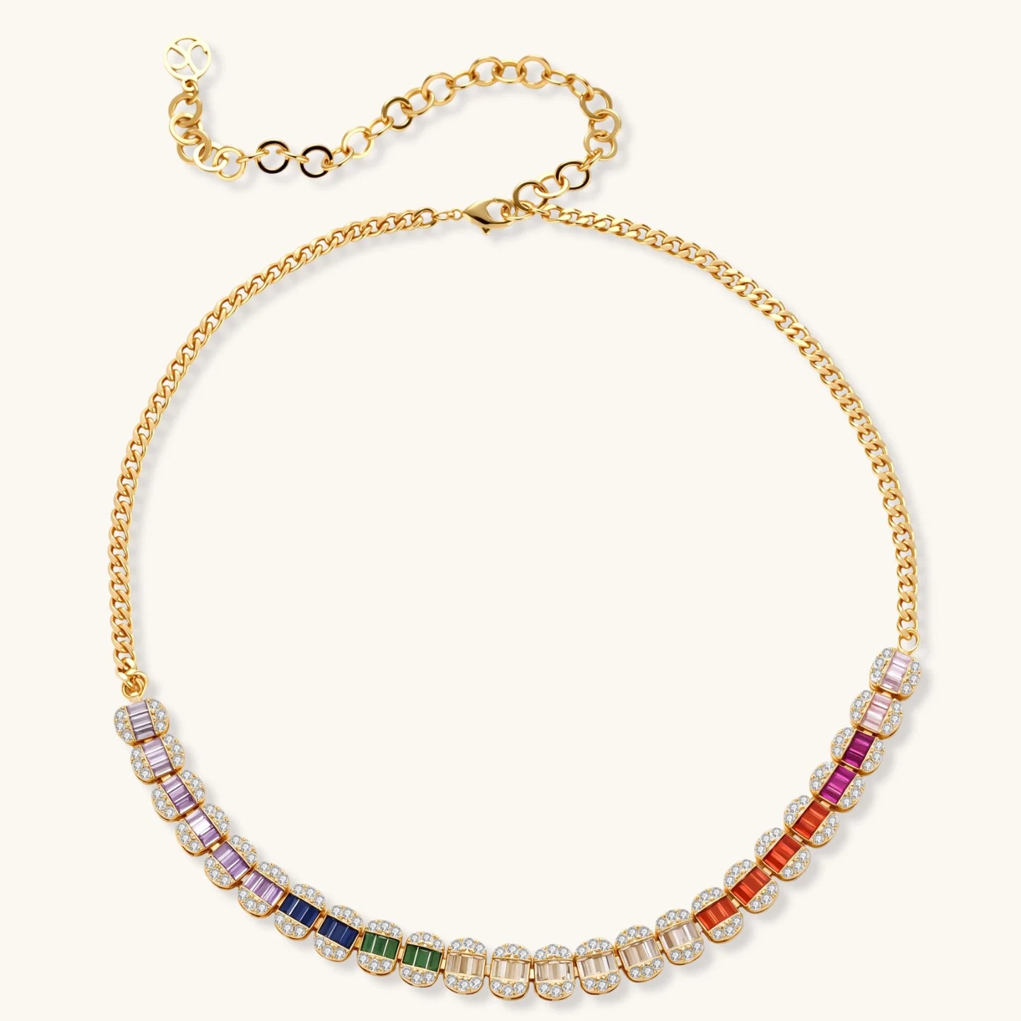 Gold-plated jewelry set featuring rainbow baguette-cut cubic zirconia stones in geometric design on cream background