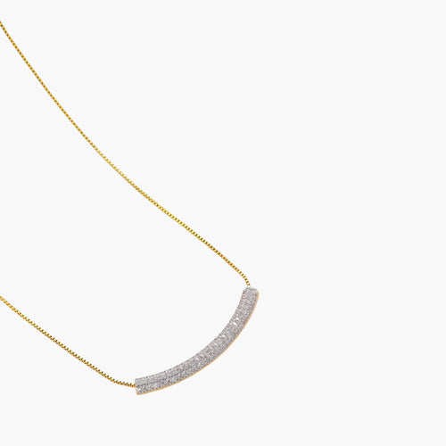 Gold-plated curved necklace, hoop earrings, and adjustable ring with pavé cubic zirconia stones on cream background.