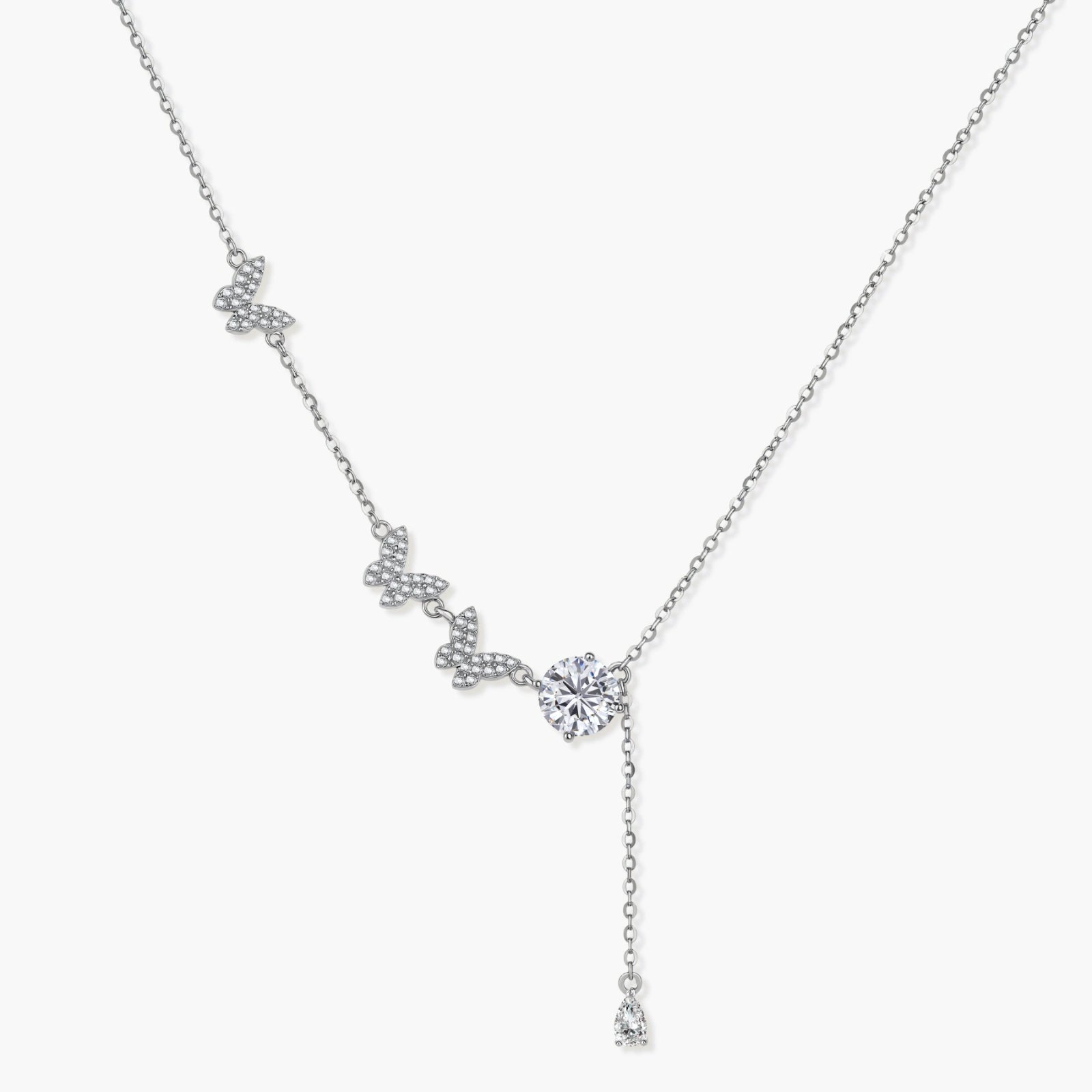Sterling silver lariat necklace featuring three delicate butterfly charms and a brilliant round moissanite drop.