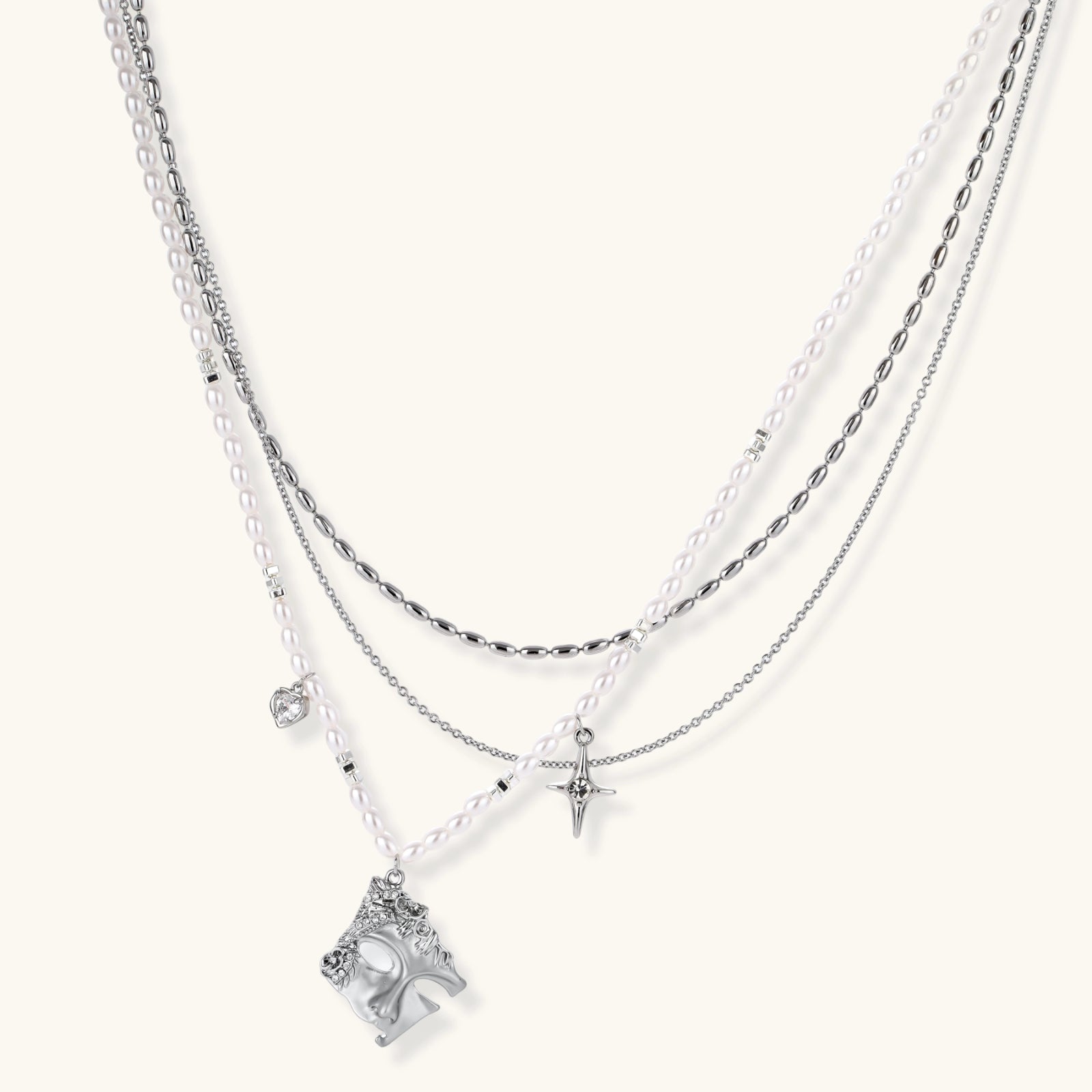 Multi-strand layered necklace set with silver chains, white pearls, star charm, heart pendant, and ornate decorative piece