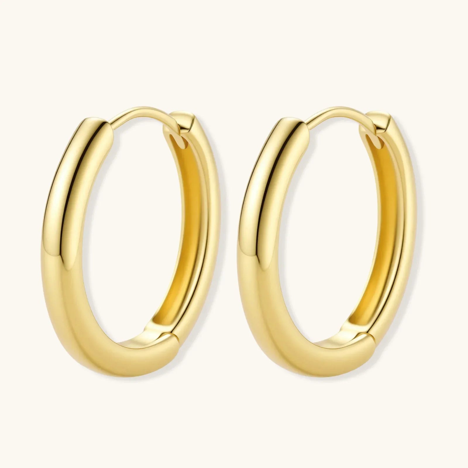 Polished gold-plated sterling silver hoop earrings with hinged closure mechanism on white background.