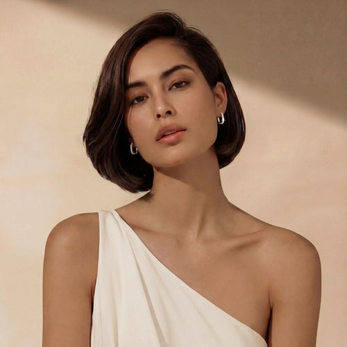 Elongated rectangular huggie earrings in warm gold tone, adorned with shimmering pavé stones for a radiant finish.