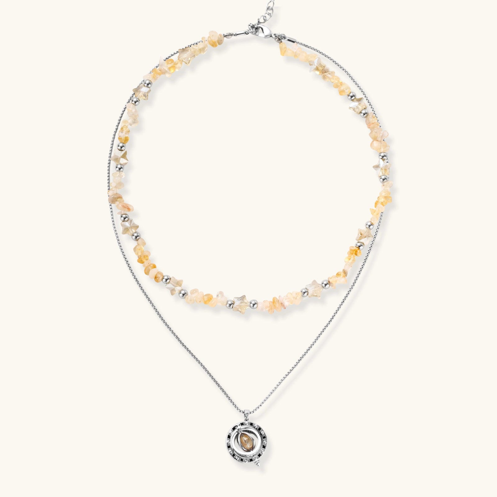 Two-layer necklace with natural stone chips and eco-brass beads, featuring a circular wrapped pendant on cream background.