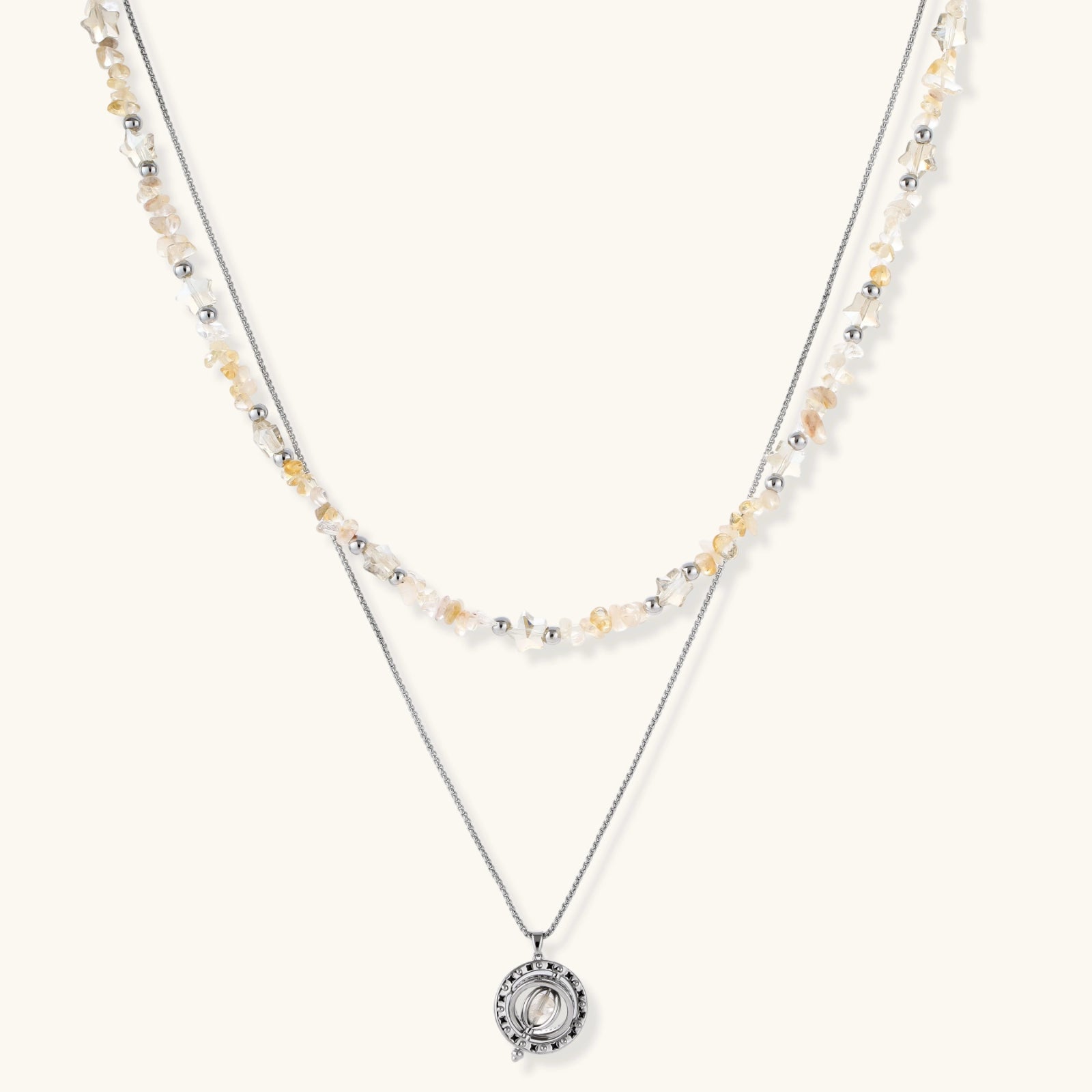 Two-layer necklace featuring raw citrine-toned chips, silver beads, and a circular openwork pendant with zirconia.