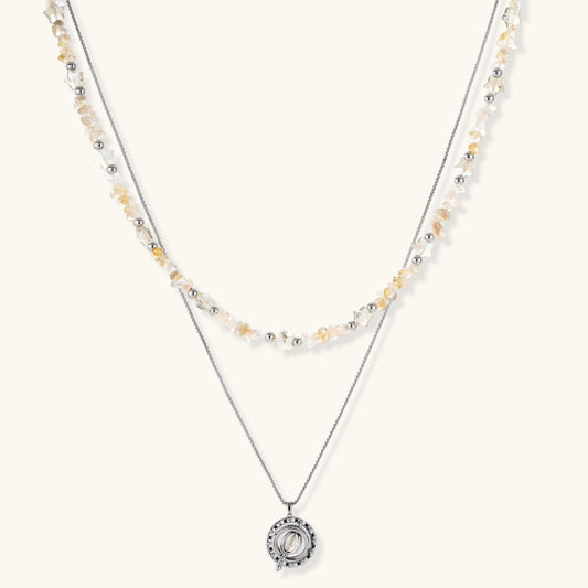 Two-layer necklace featuring raw citrine-toned chips, silver beads, and a circular openwork pendant with zirconia.