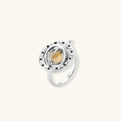 Adjustable ring featuring a honey-gold cabochon, surrounded by intricate star motifs and delicate beadwork in slim silver bands.