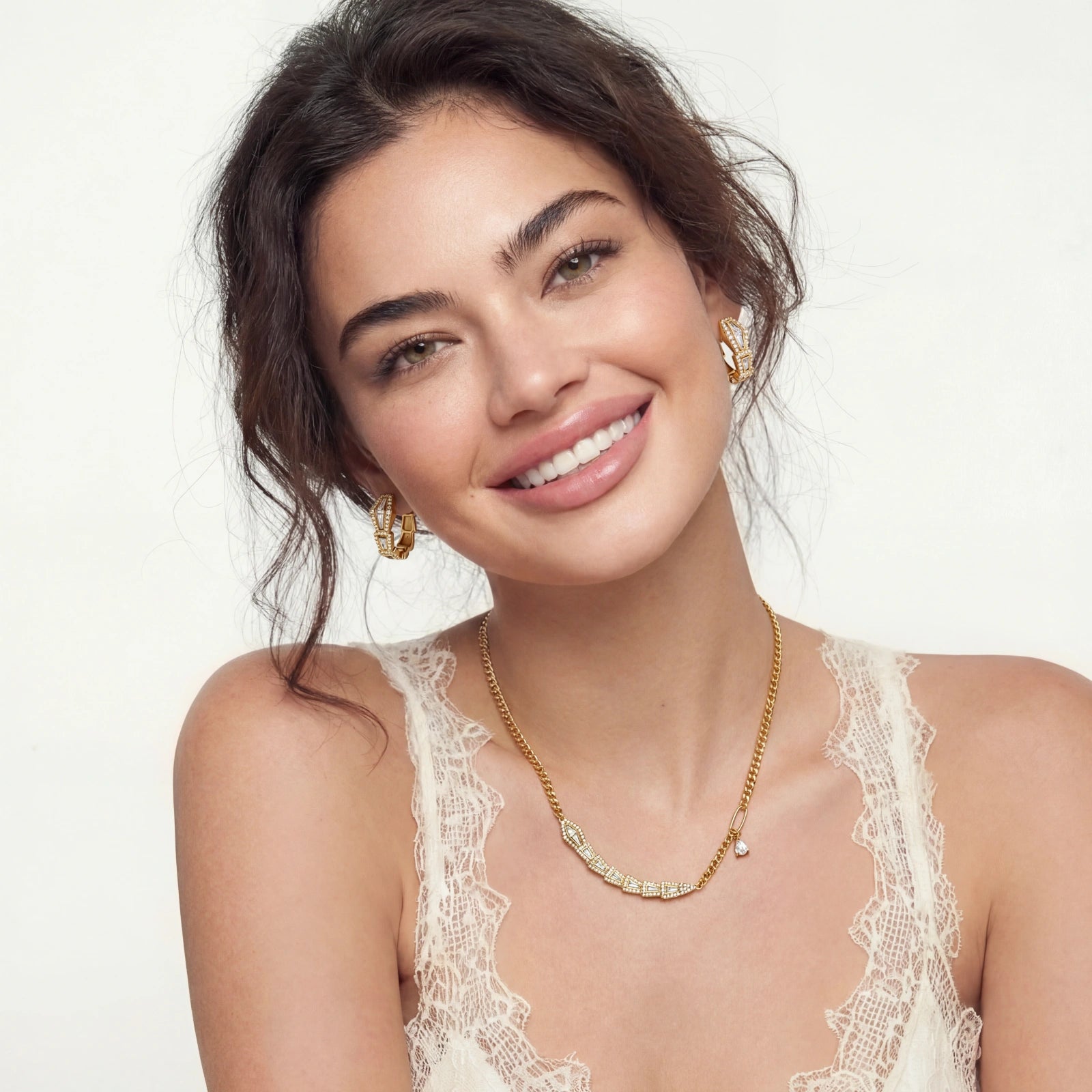 Model showcasing a curb-chain necklace with sparkling stones and coiled snake huggies, exuding elegance and sophistication.