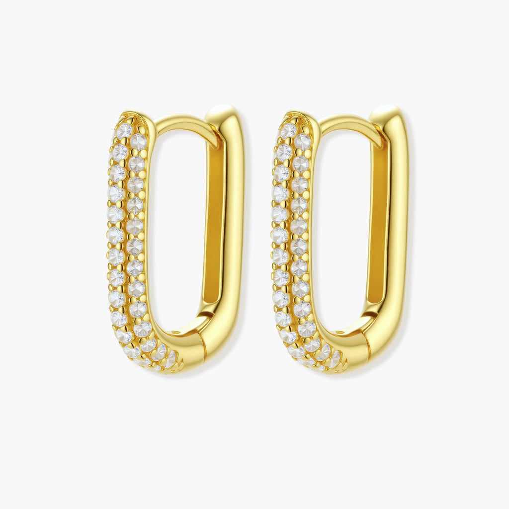 Close-up of small sterling silver huggie hoops completely covered in sparkling clear crystals with hinged closure