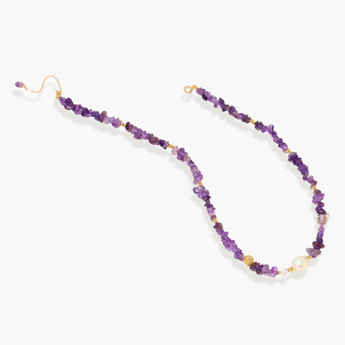 Beaded necklace with purple amethyst chips, freshwater pearls, and gold accents on white background.
