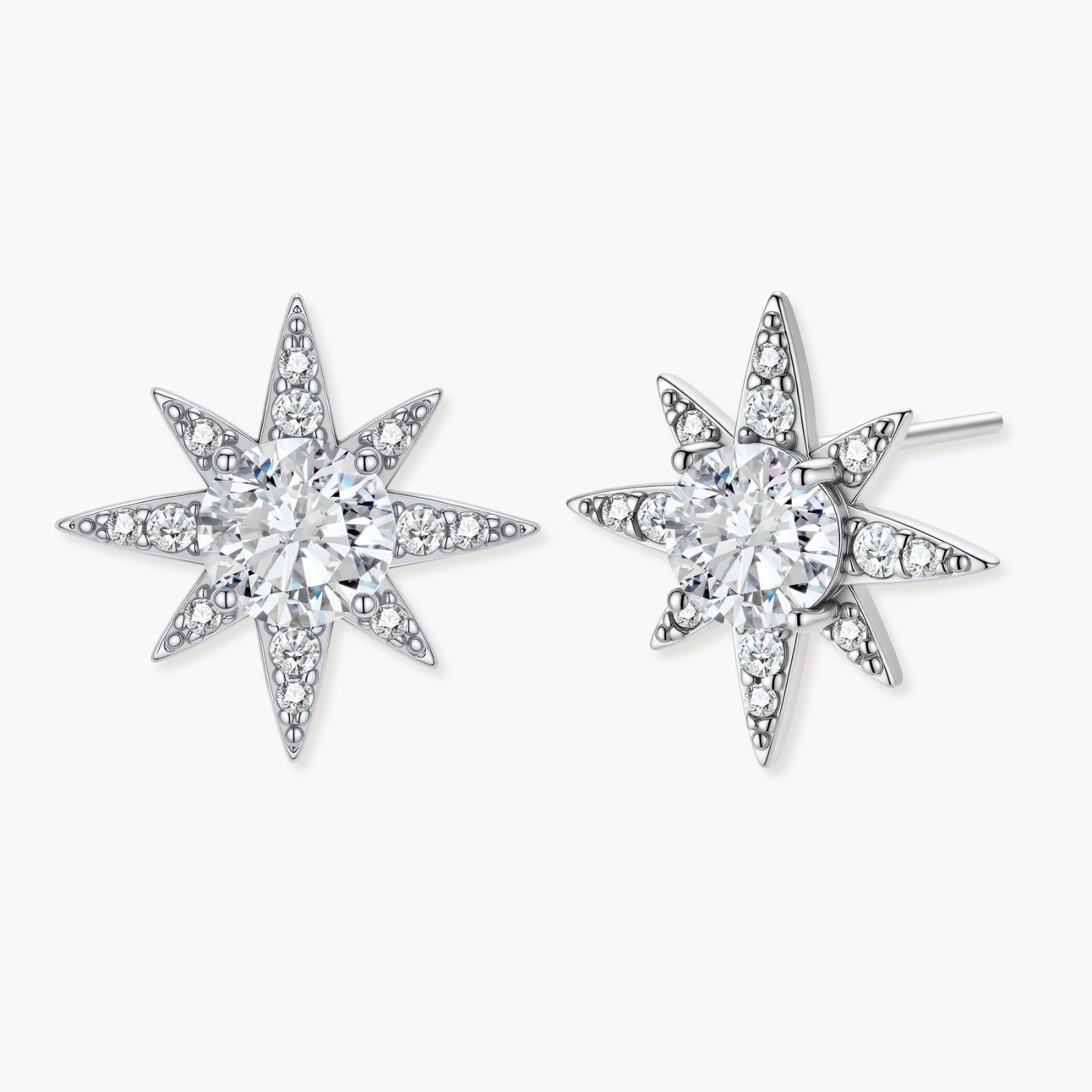 Star-shaped sterling silver earrings featuring a central round moissanite stone surrounded by delicate pavé accents.