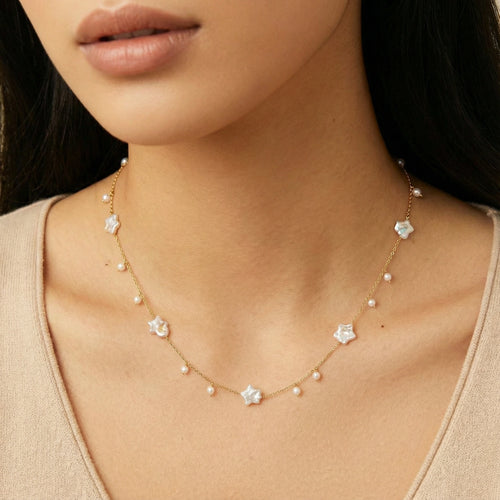 Gold vermeil chain adorned with star-shaped baroque pearls and round freshwater pearls, elegantly worn around the neck.