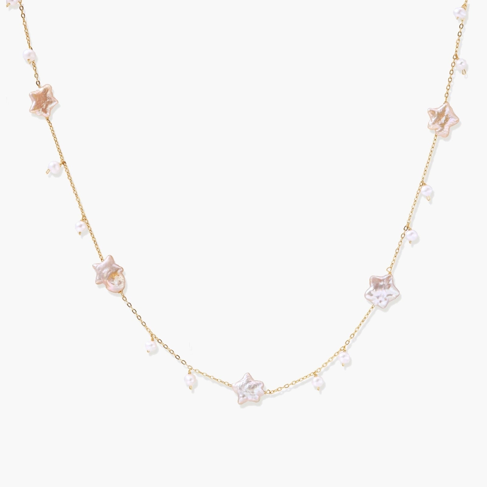Gold vermeil chain adorned with iridescent star-shaped baroque pearls and delicate round freshwater pearl drops.