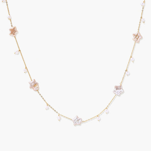 Gold vermeil chain adorned with iridescent star-shaped baroque pearls and delicate round freshwater pearl drops.