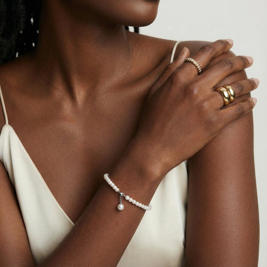 Delicate bracelet showcasing lustrous freshwater pearls and a graceful drop pearl, exuding timeless elegance.
