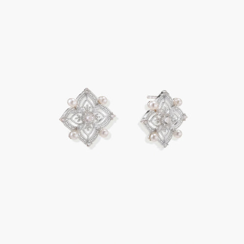 Delicate sterling silver quatrefoil stud earrings featuring four elegant freshwater pearls, exuding timeless sophistication.