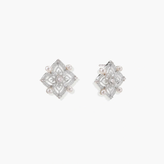 Delicate sterling silver quatrefoil stud earrings featuring four elegant freshwater pearls, exuding timeless sophistication.