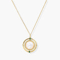 Gold pendant necklace with circular orbital design, iridescent mother-of-pearl center, and green zirconia accents