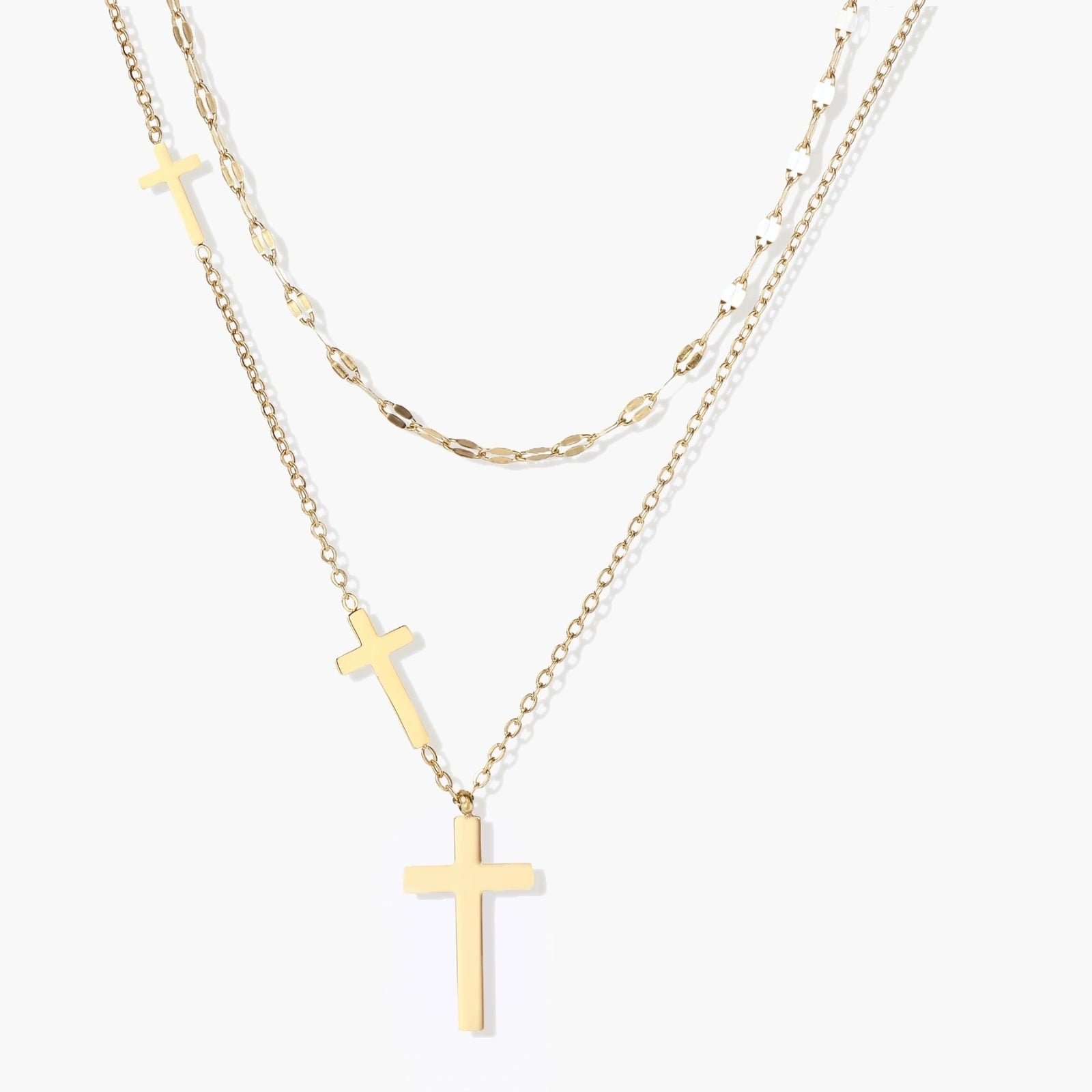 Layered gold necklace set featuring a shorter mirror-link chain and a longer chain with three polished cross pendants.