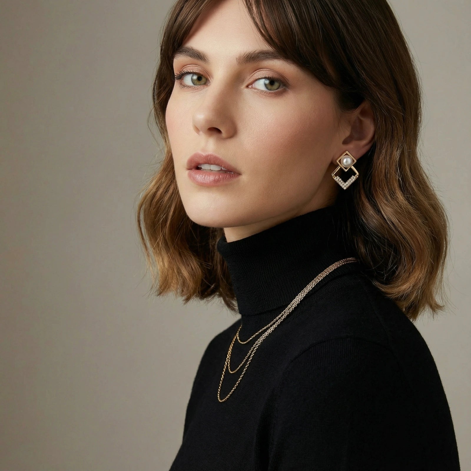 Geometric gold earrings featuring a lustrous freshwater pearl and delicate crystal accents for an elegant touch.