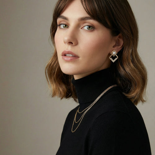 Geometric gold earrings featuring a lustrous freshwater pearl and delicate crystal accents for an elegant touch.