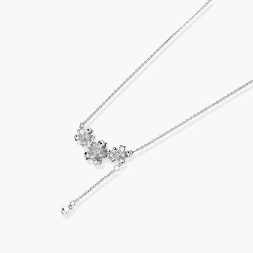 White gold plated Y-shaped necklace with three dimensional flower charms and adjustable drop pendant