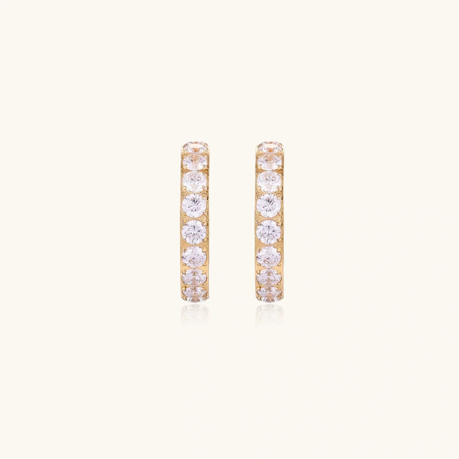 Gold pavé hoop earrings with two freshwater pearls nestled inside the curved design, featuring crystal-studded outer edge.