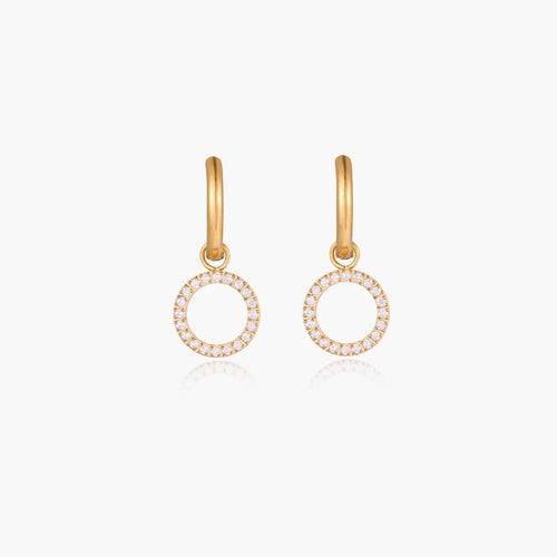 Gold-plated huggie hoop earrings with CZ-studded open circle charms on beige background