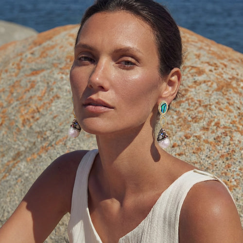 Gold drop earrings featuring unique baroque pearls, iridescent abalone, and crystal-encrusted caps on twisted loops.