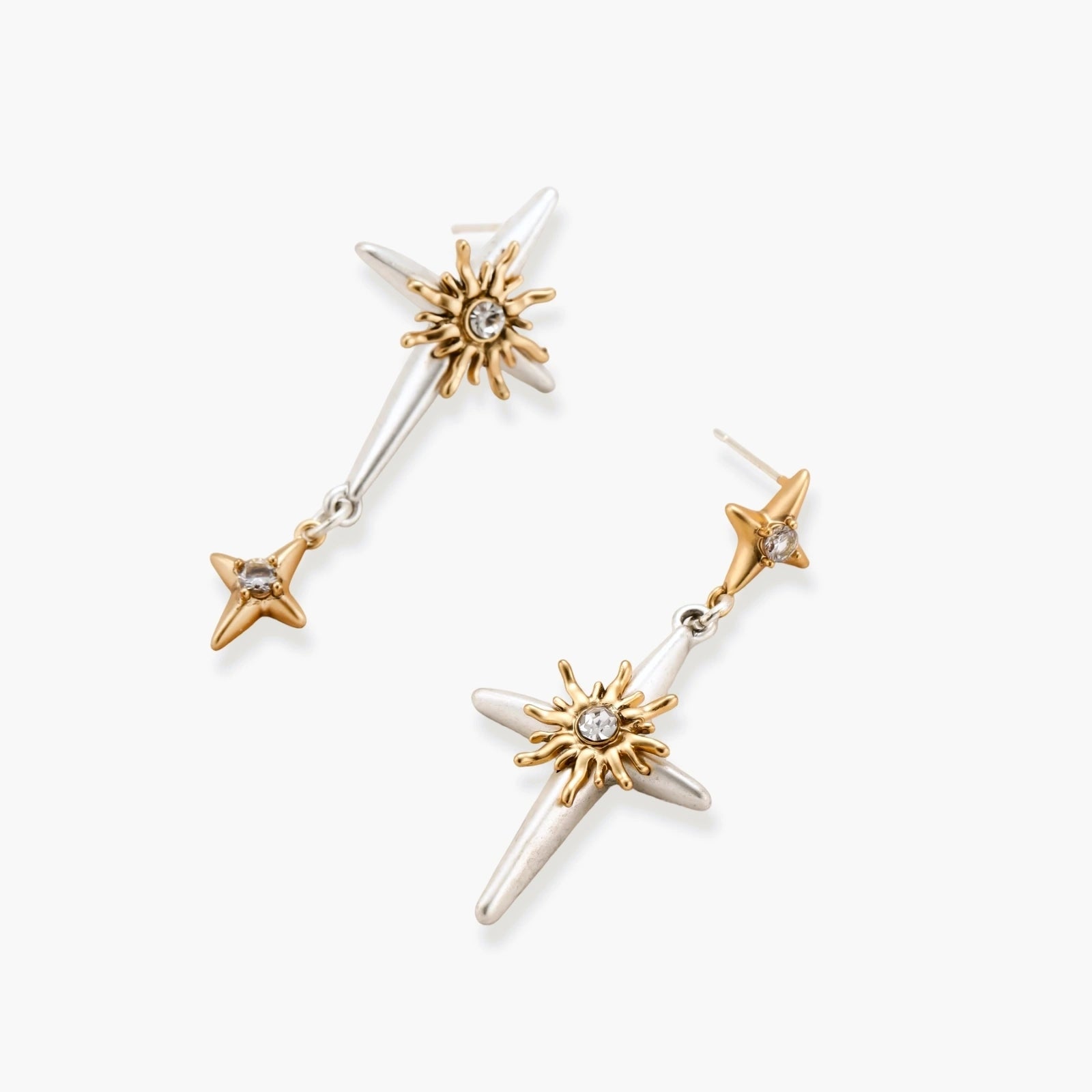 Layered silver-toned necklace set with cross pendant and gold sun charm detail, matching drop earrings on white background.