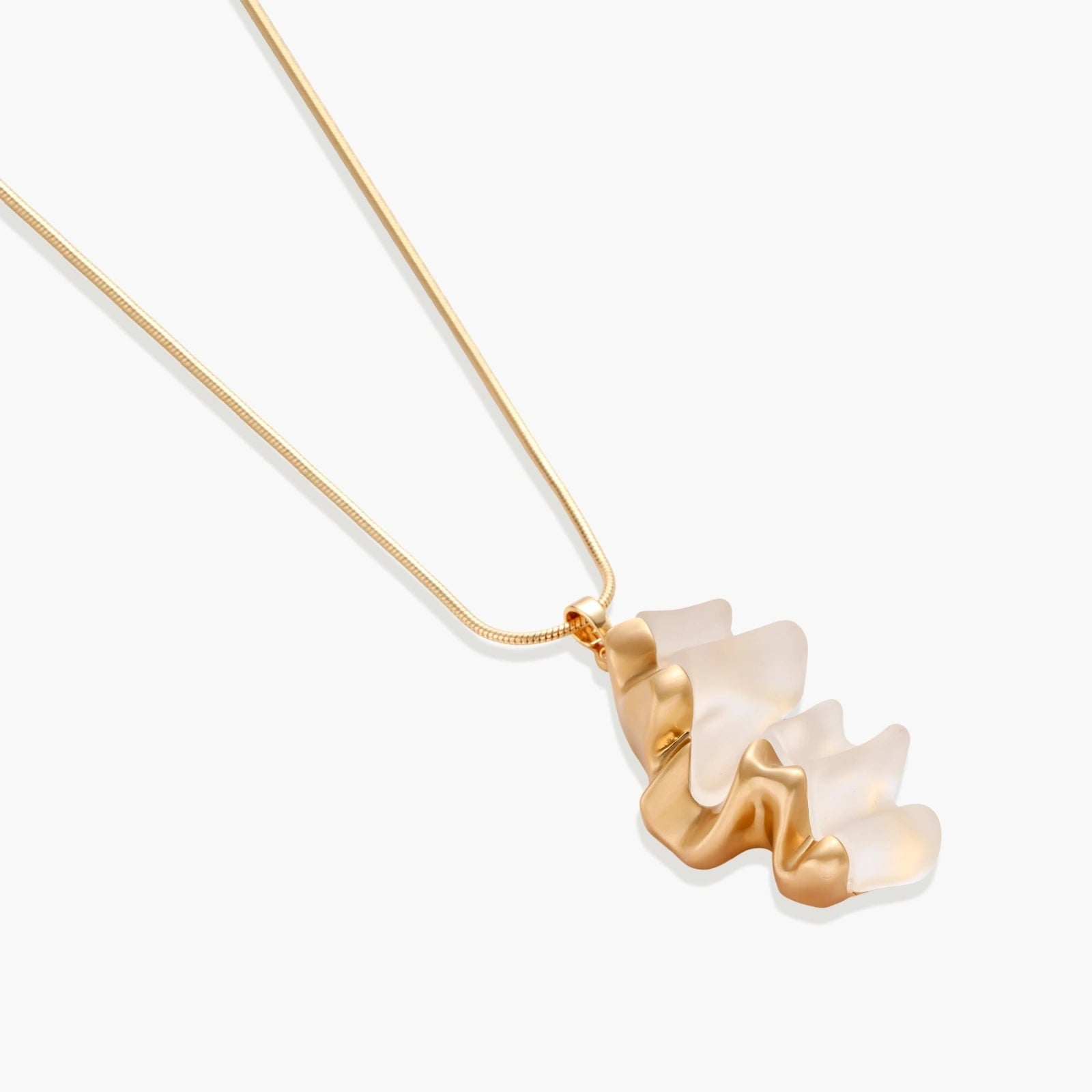 Sculptural gold-toned jewelry set featuring wavy organic earrings and matching necklace pendant with translucent resin accents.