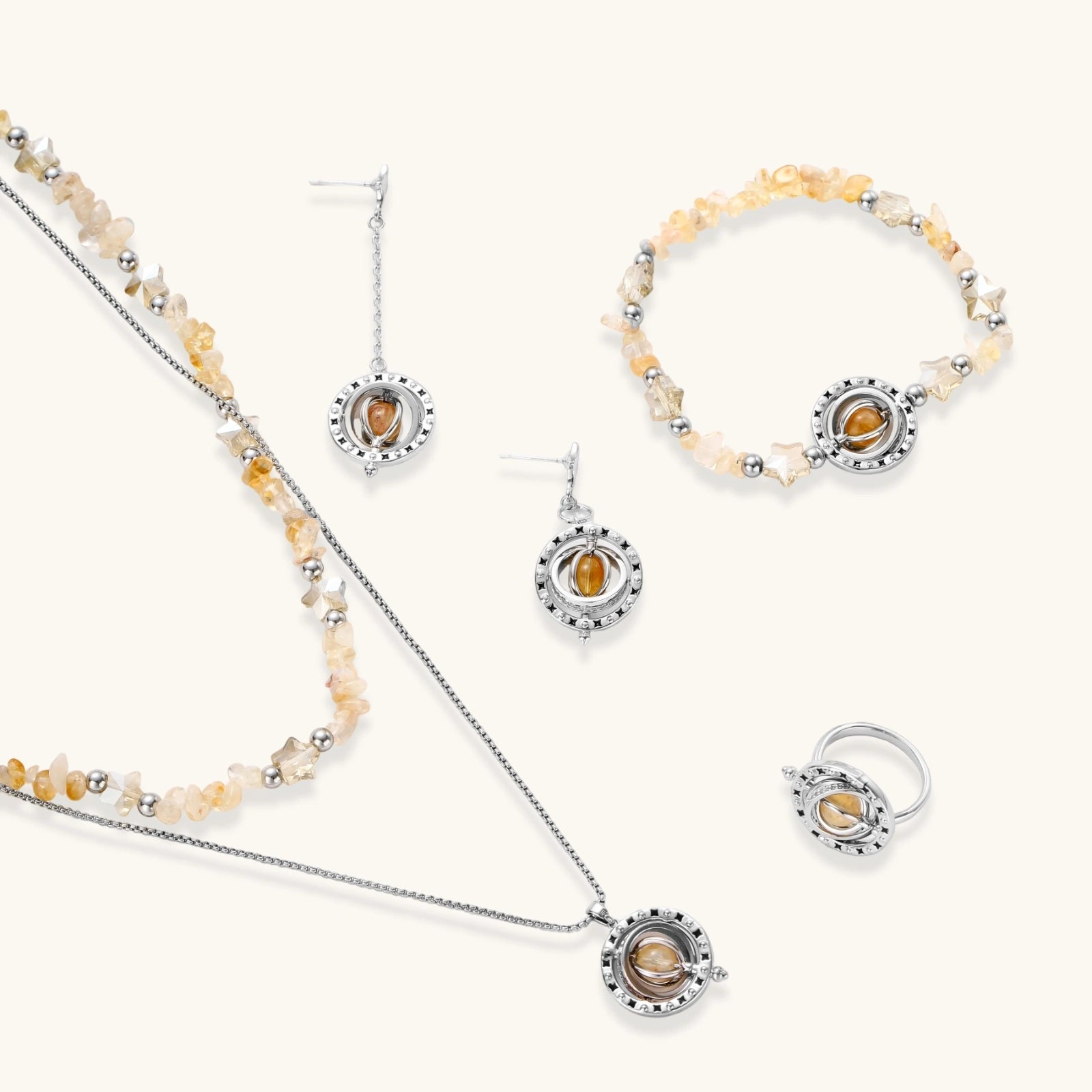 Jewellery set featuring a necklace, earrings, bracelet, and ring with amber beads and citrine-hued chip stones.