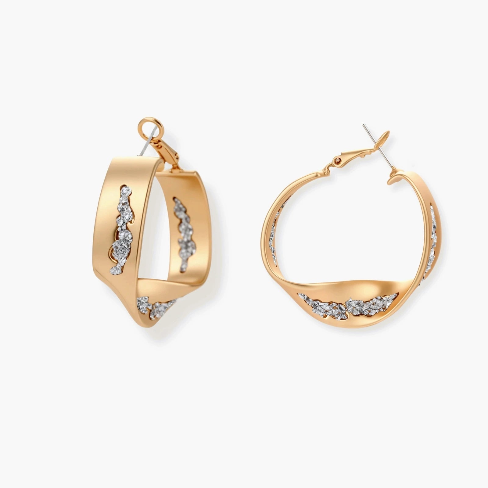 Sculptural gold twisted hoops featuring silver crystal fragments and a lustrous satin finish.