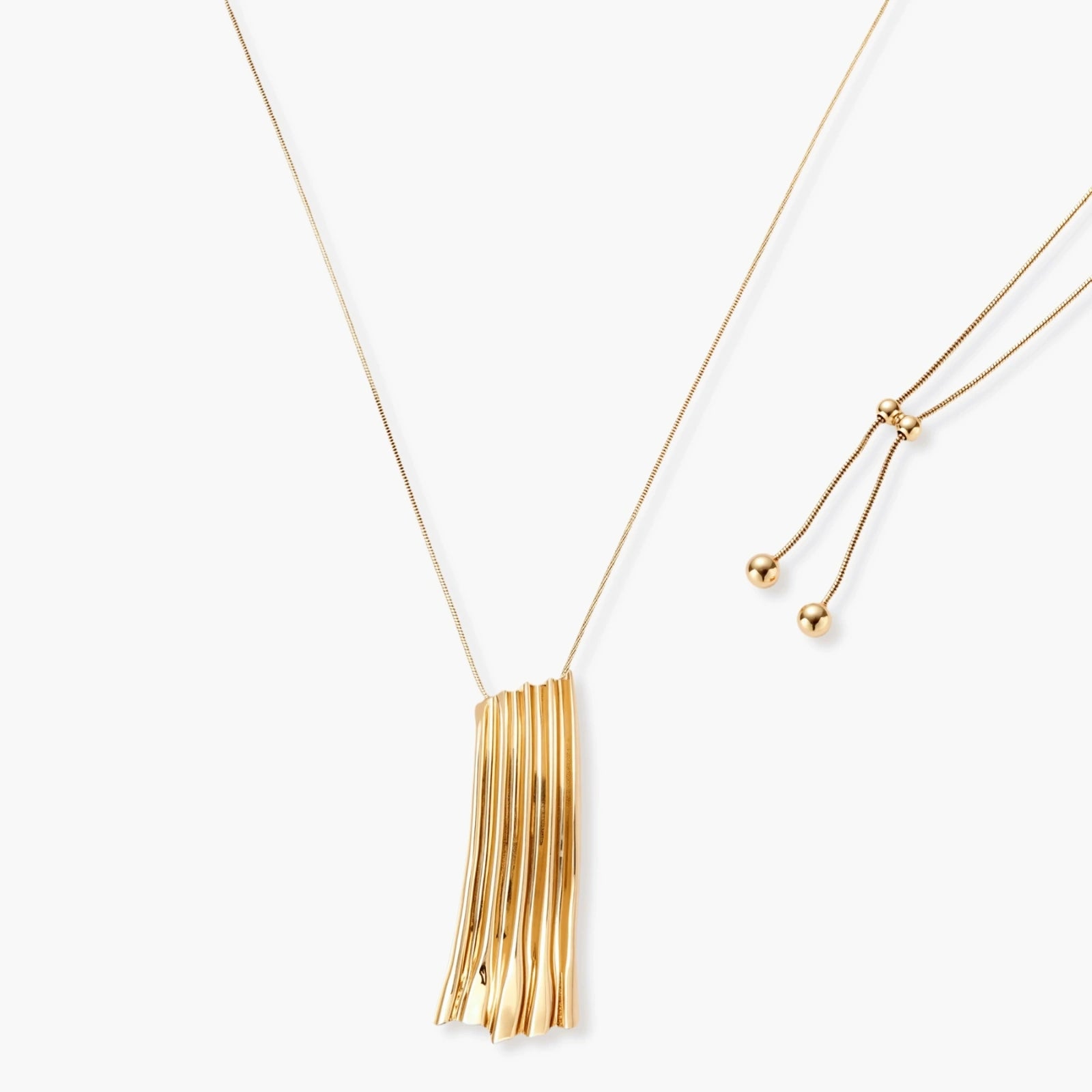 Modern adjustable necklace featuring geometric ribbed pendant with vertical lines in gold and silver finish options.